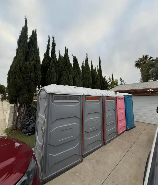 Row of porta potties on a driveway