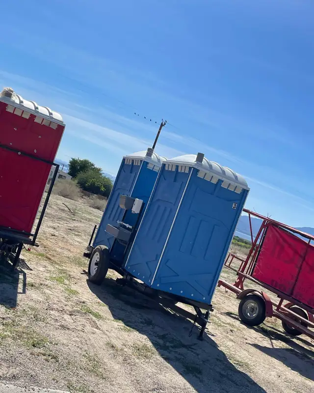 Porta potty trailer on a dirt lot